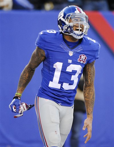 FILE - In this Dec. 14, 2014, file photo New York Giants wide receiver Odell Beckham Jr. (13) reacts after making a catch against the Washington Redskins during the fourth quarter of an NFL football game in East Rutherford, N.J. A large chunk of fantasy footballers headed to the championship this weekend can thank New York Giants receiver Odell Beckham Jr., whos on more teams in the fantasy final than any other NFL player. Last week, he won one fantasy player $2 million.  (AP Photo/Bill Kostroun, File)