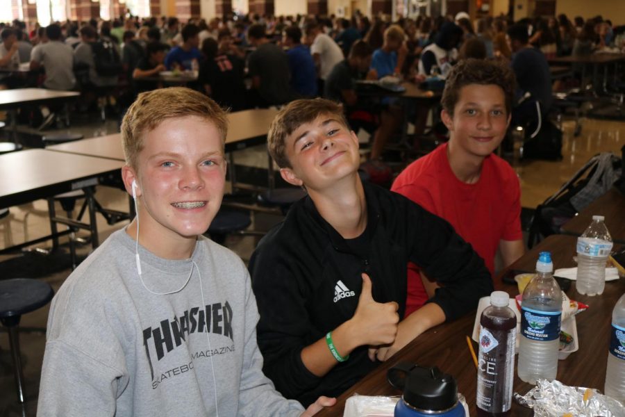 A group of freshman boys pose for a picture in the high school cafeteria
