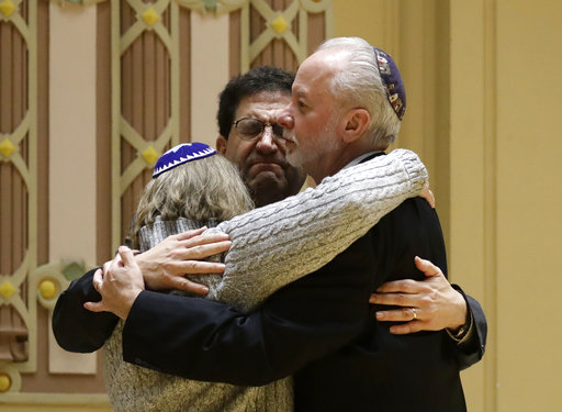 Rabbi Jeffrey Myers, right, of Tree of Life/Or LSimcha Congregation hugs Rabbi Cheryl Klein, left, of Dor Hadash Congregation and Rabbi Jonathan Perlman during a community gathering held in the aftermath of a deadly shooting at the Tree of Life Synagogue in Pittsburgh, Sunday, Oct. 28, 2018. (AP Photo/Matt Rourke)