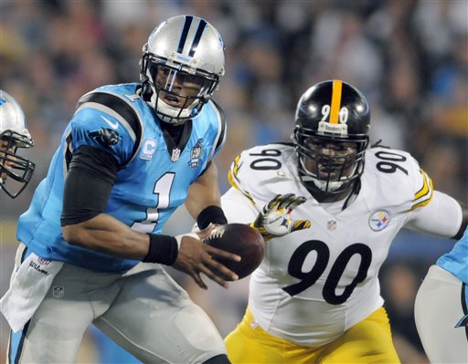 Carolina Panthers Cam Newton looks to hand of the ball as Pittsburgh Steelers Steve McLendon draws near, Sept. 2016. 