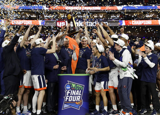 Virginia players celebrate with the championship trophy after defeating Texas Tech 85-77 in the overtime in the championship of the Final Four NCAA college basketball tournament, Monday, April 8, 2019, in Minneapolis. (AP Photo/David J. Phillip)