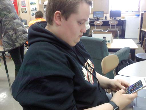 Brandon playing on his phone while in class. 