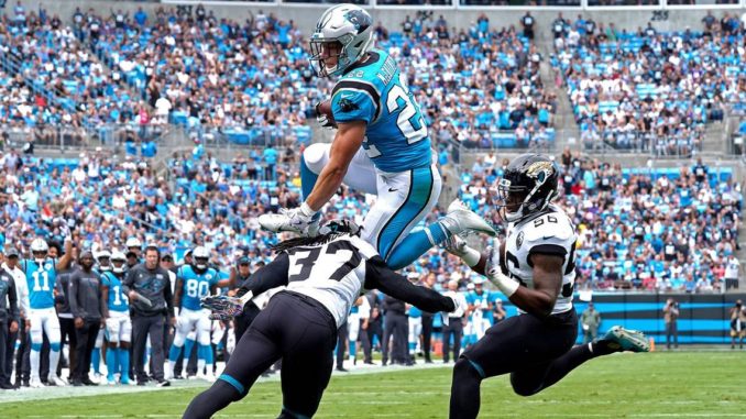Panthers RB Christian McCaffrey leaps over defenders for a Touchdown. Many consider him to be a front runner for the MVP Award.