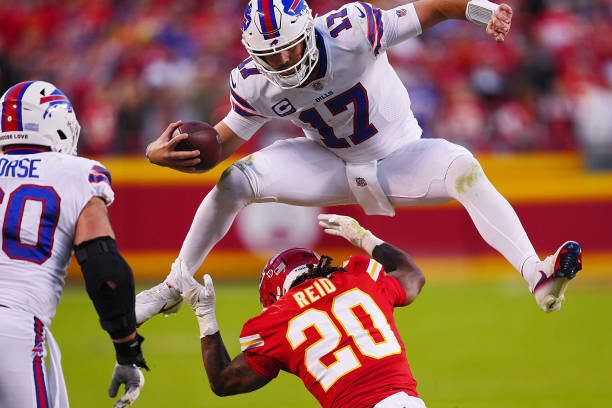 KANSAS CITY, MISSOURI - OCTOBER 16: Josh Allen #17 of the Buffalo Bills hurdles over Justin Reid #20 of the Kansas City Chiefs during the fourth quarter at Arrowhead Stadium on October 16, 2022 in Kansas City, Missouri. (Photo by Jason Hanna/Getty Images)