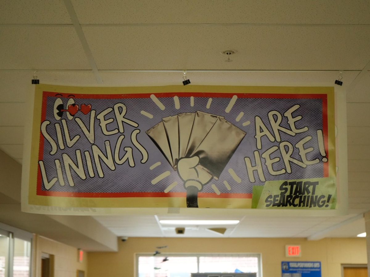 The hanging poster in the art hallway, right above the other poster that informs students about Silver Linings. 