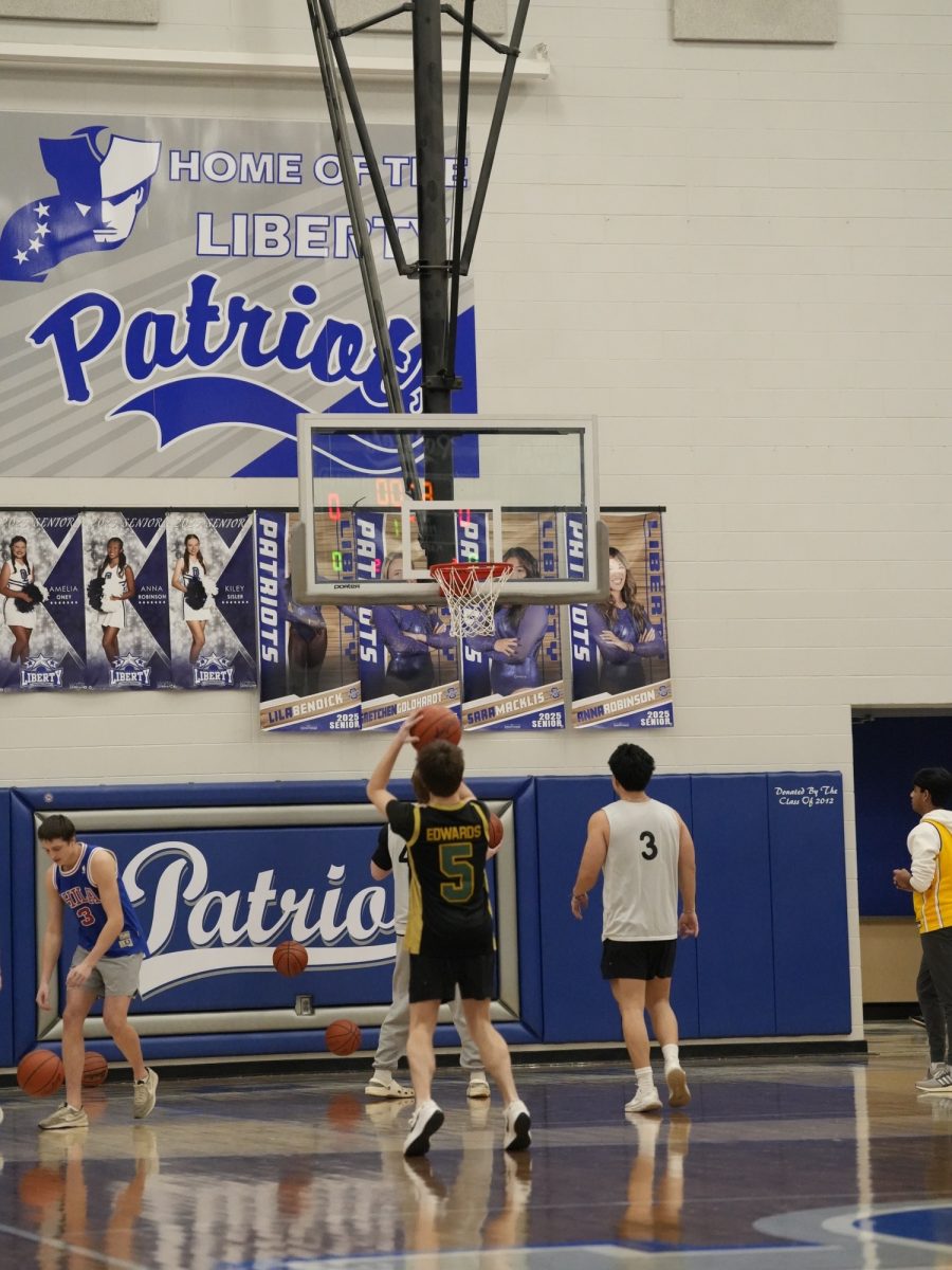 The students lining up to shoot during the teacher V student game. 