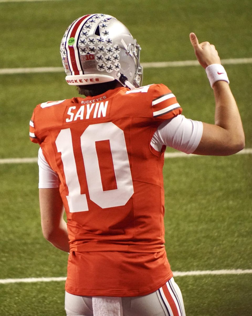 Sophomore quarterback Julian Sayin gives his coach a thumbs up from the field. Sayin completed 23/31 passes, good for 184 yards and a touchdown along with a 134.7 QBR.