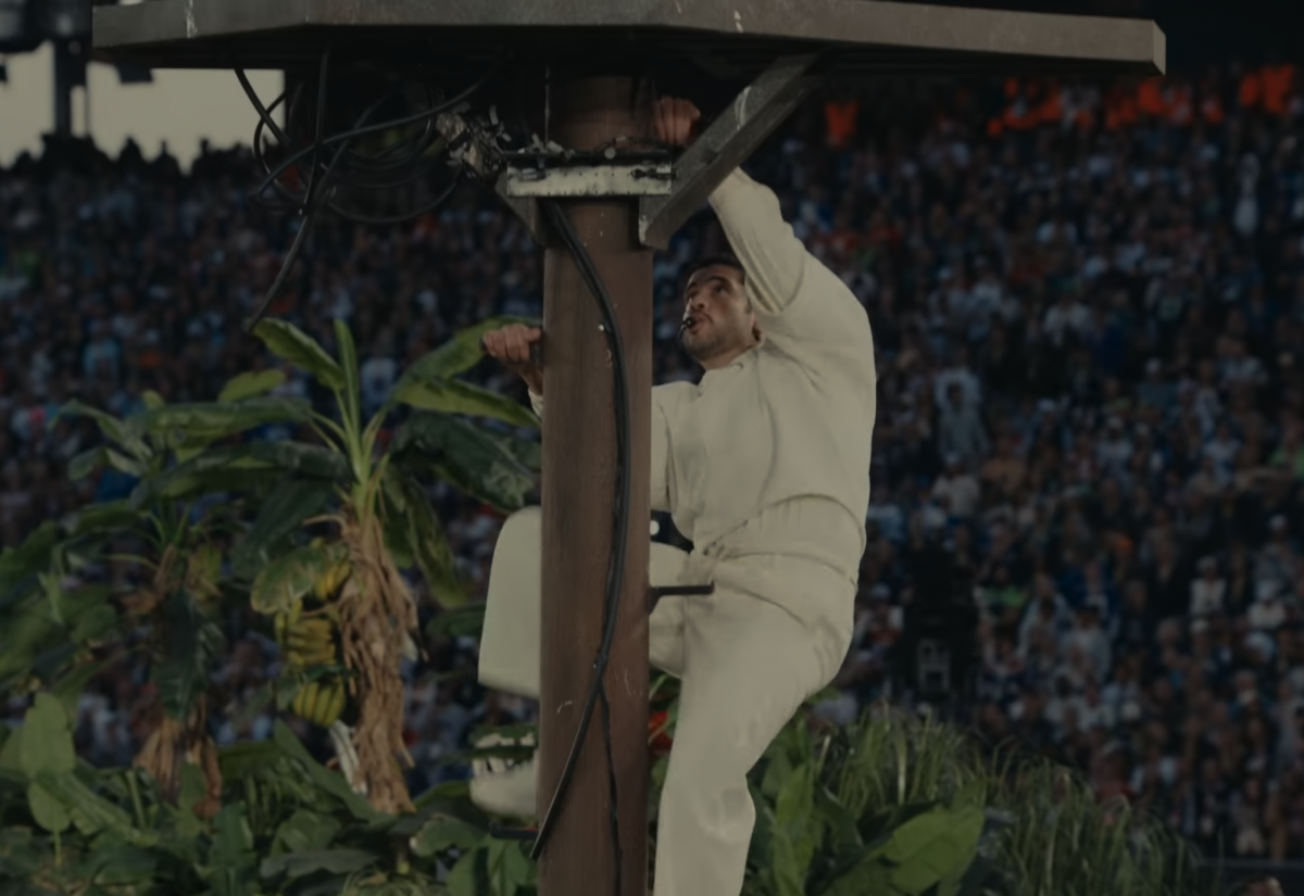 Bad Bunny climbs a utility pole during his Super Bowl halftime show.